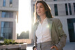© opolja - Businesswoman portrait. Caucasian female business person standing outdoor looking at camera