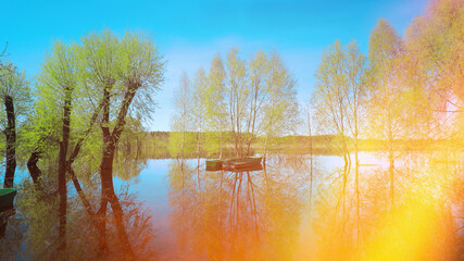 Sticker - Boats Moored Near Trees That Standing In Water During Spring Flood Floodwaters. Scenic View Bright Sunbeams. Beautiful Spring Landscape With Reflection In River. Sun Shining With Sun Rays.