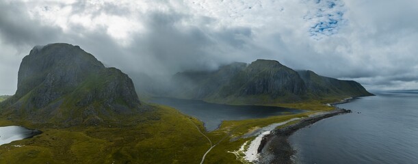 Poster - Aerial view of the rocky hills at the shore in Lofoten on a foggy day