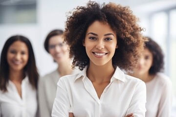 A business team with a curly-haired, pretty, and smiling black woman as the leader in a modern and bright office can represent diversity, inclusion, and leadership. Generative AI
