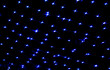 Dark blue lights bokeh on the ceiling of a building in the night. Abstract background for design.