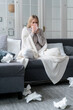 © brizmaker - young woman with fever and flu feeling unwell at home