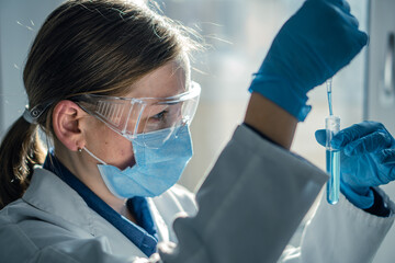 Aufkleber - Medical research laboratory. A scientist works with a pipette and a test tube. Scientific laboratory of biotechnology, development of medicine and research in chemistry, biochemistry and experiments.