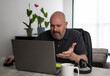 © Odu Mazza - Angry brazilian middle-aged man using a laptop working at home