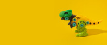 Plastic Dinosaur Toy On Yellow Background. Banner