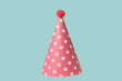 Bright and colorful birthday cap isolated on a blue background.