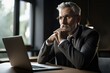 © oleksandr.info - Frustrated businessman sitting at the desk with laptop and thinking about future