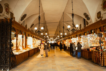 krakow, poland - 6th march, 2023: tourist buy souvenirs in famous cloth hall market tourist attracti