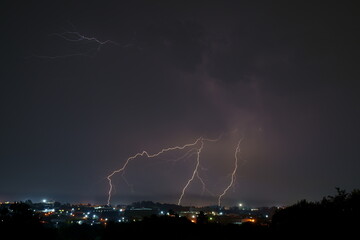 bright lightning bolts over the commercial and urban area of kempton park. the unpredictability of m