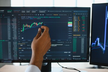 Businessman hand analysing financial stock market graph on board. Trading data index investment growth chart. Cryptocurrency and Forex Concept.