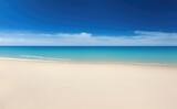 Fototapeta Morze - Empty beach with blue water sky and clouds