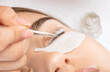 © Dimid - Make-up artist makes the procedure of lamination and dyeing of eyelashes to a beautiful woman in a beauty salon. Eyelash extensions. Eyelash lifting