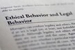 © Jon - legal or law book with ethical behavior and legal behavior focused in closeup of explanation