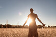 © kieferpix - woman walking in the field early morning enjoying peace in nature