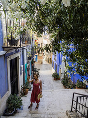 Wall Mural - Tourist take a selfie in Santa Cruz neighborhood, Alicante, Valencian Community, Spain.