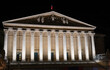 Facade of the French National Assembly illuminated at Night (Assemblee Nationale, Palais Bourbon, the French Parliament) after 2023 renovation - Paris, France