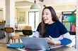 © kues1 - young pretty woman laughing out loud at some hilarious joke. telecommuting concept
