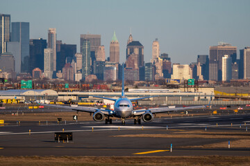 Airplane of airlines is going on taxiway after landing in Newark airport the USA. Aircraft on background of New York