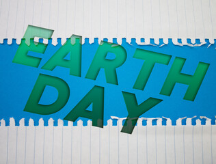 Poster - Earth Day text with Torn, Crumpled White Paper on colored background.