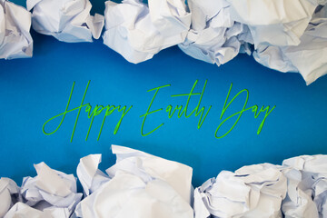 Poster - Earth Day text with Torn, Crumpled White Paper on colored background.