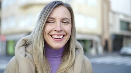 Poster - Young blonde woman smiling confident standing at street