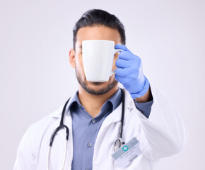 Sticker - Hand, coffee and break with doctor man in studio on a gray background for a drink to start his morning. Medical, healthcare and beverage with a medicine professional holding a cup or mug for tea