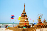 Fototapeta Kosmos - sand pagoda and wall was carefully built, and beautifully decorated in Songkran festival