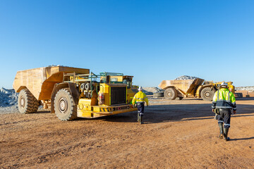 Two miners heading to their trucks at a mine site