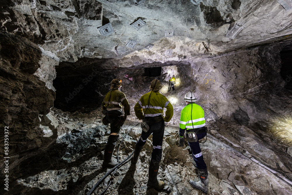 Miners underground inspecting work in progress at a mine site in ...