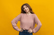 © makedonski2015 - This photo captures the natural beauty of a young woman with long hair. Against a cheerful yellow background, her cozy sweater and relaxed posture create a mood of comfort and ease
