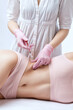 © Dimid - beautician makes lipolytic injections to burn fat on woman's belly and waist. Women's aesthetic cosmetology in a beauty salon. The concept of cosmetology.