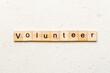 volunteer word written on wood block. volunteer text on table, concept