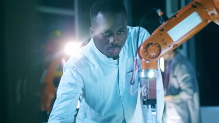 Wall Mural - african researcher is examining a robotic mechanism in motion