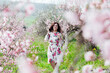 © dmitriisimakov - woman in peach garden rose trees nature parks walk