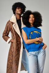 Poster - Portrait of african american couple wear stylish  90s fashion clothes with afro hairstyle isolated on gray background