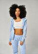 © kiuikson - Beautiful african american girl with an afro hairstyle wear blue velour tracksuit