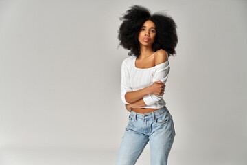 Poster - Attractive african american girl with an afro hairstyle isolated on gray background