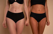 © gpointstudio - Two unrecognizable women in black underwear standing and holding hands
