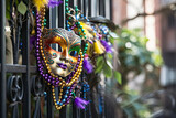 Fototapeta Koty - New Orleans Mardi Gras mask with bead necklaces hanging on wrought iron fence in the day created with Generative AI technology