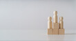 © Suriyawut - wooden figures peg doll standing on the podium of wooden cube blocks with copy space. ranking and strategy concept.