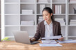 © David - Business Asian woman working at office with documents on her desk, calculator to calculate planning analyzing the financial report, business plan investment, finance analysis concept
