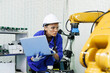 © gumpapa - female automation machine engineer student study and inspection control robot arm machine in university or factory workshop. ai robot technology new innovation trend of manufacturing in industry 5.0