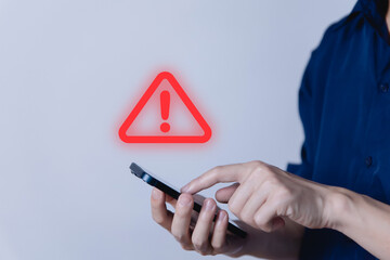 Wall Mural - businessman using smartphon showing warning triangle and exclamation sign icon caution of dangerous 