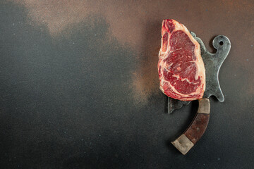 New York steak with salt and rosemary, raw marbled beef strip loin steak on a dark background, Long banner format. top view