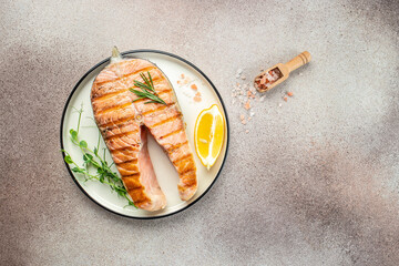 Wall Mural - Fresh cooked delicious salmon steak with spices and herbs baked on a grill. Restaurant menu, dieting, cookbook recipe top view