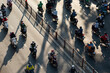 Road with motorcycle traffic looking down from high angle in beautiful late afternoon light with long shadows in Ho Chi Minh City, Vietnam.