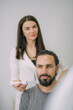 © Anna - Portrait of a young beautiful woman beautician in a medical white uniform and a young bearded man patient