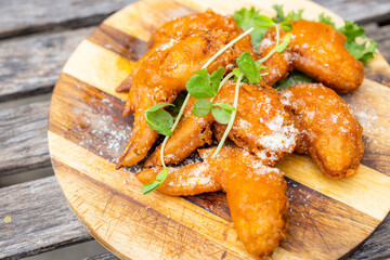 Poster - Grill fry chicken wings over wooden board