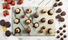  Chocolates And Strawberries Are Arranged On A Marble Board.  Generative Ai