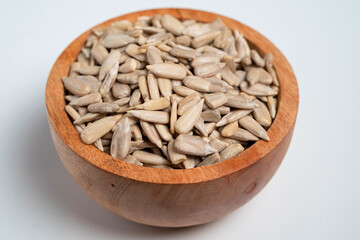 Wall Mural - Sun flower seed on wood bowl isolated on white background